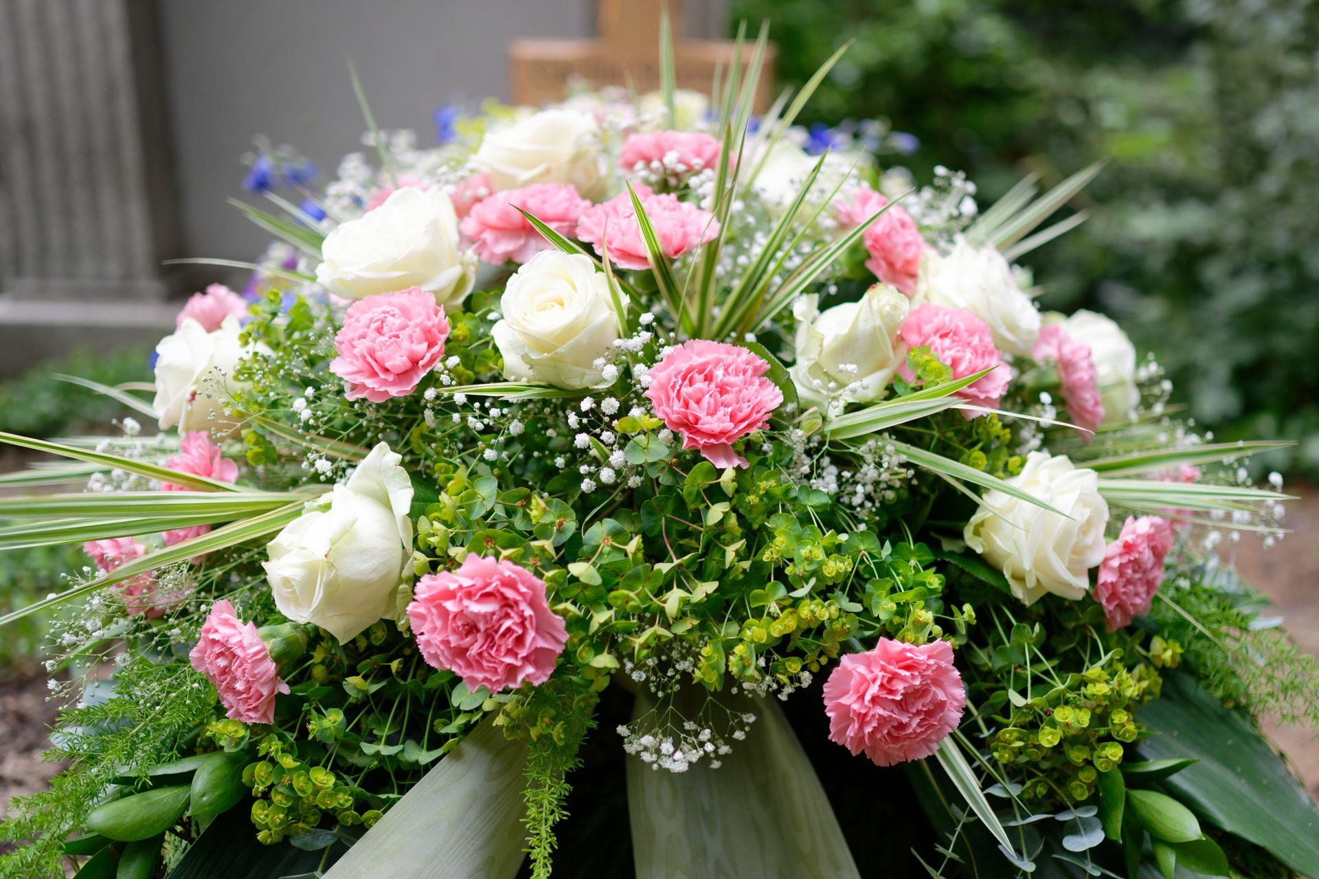 pastel funeral flowers on a grave
